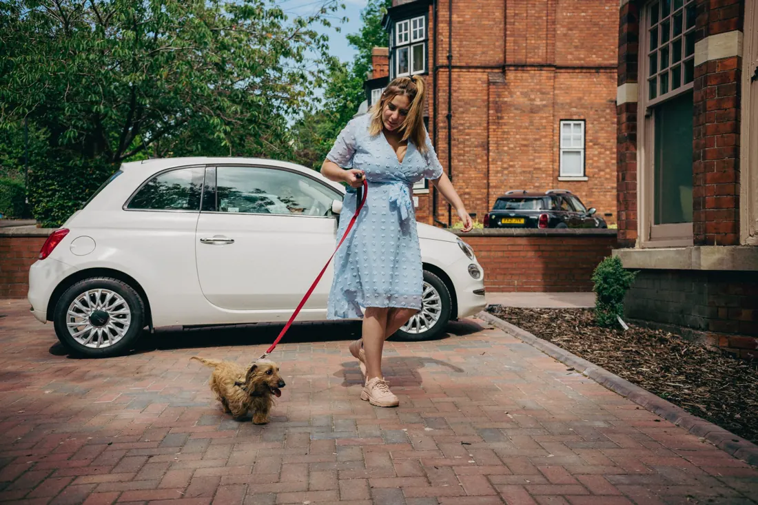 A tenant walking her dog on the driveway