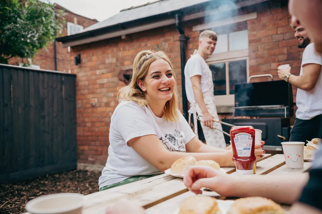 Friends round the barbecue in the Mutt Mansion garden